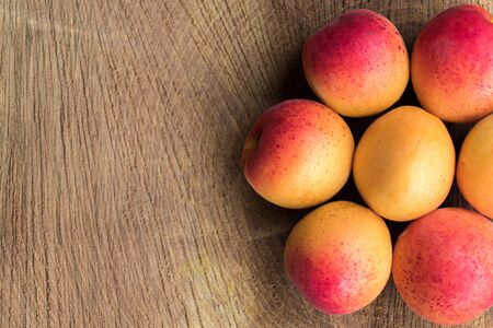 Apricot fruit. Fresh apricots on a wooden background. Close up