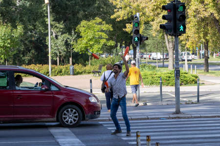 Novi Sad, Serbia - August 31, 2020: A man juggling at a pedestrian crossing in Novi Sadのeditorial素材