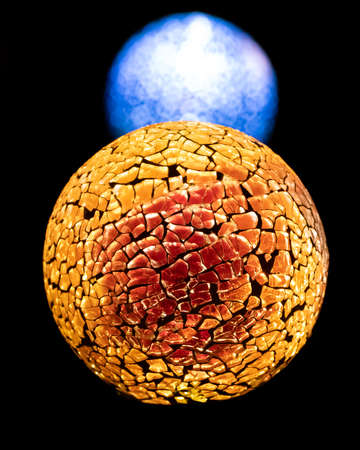 Golden planet with white blue star in deep black space.の写真素材