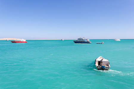 Hurghada, Egypt - September 23 2021: Orange Bay Beach with crystal clear azure water and boat ships with touristsのeditorial素材