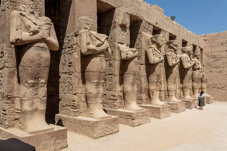 The statues of Pharaoh Ramses III as Osiris guarding the precinct of the temple of Karnak, Luxor,...