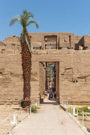 Luxor, Egypt - September 21, 2021: Travel tour group wanders through Karnak Temple. Egyptian landmark with hieroglyphics, decayed temples, obelisks, towers, and other buildings.のeditorial素材