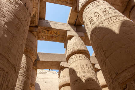 Massive columns inside beautiful Egyptian temple in Luxor with hieroglyphics, and ancient symbols. Karnak temple.のeditorial素材