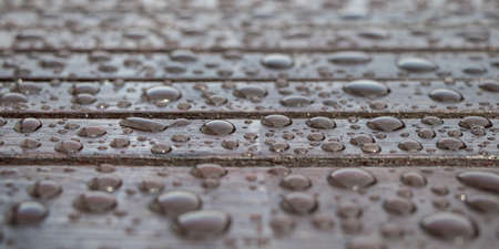 Rain drops on wooden table after rain. Selective focus