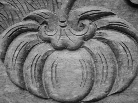 Beautiful wooden interior elements in the form of pumpkins, solid wood oak brown carved, vintage background textureの写真素材