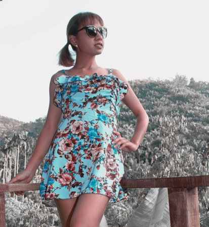 Ranong/ Thailand- 01.11.2018: A beautiful asian woman wearing black glasses and wearing a lace skirt, is happily looking at nature, with beautiful mountains, trees, sky.のeditorial素材