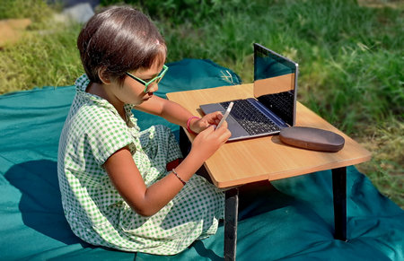 Ranong/ Thailand- 04.05.2020: asian girl study online learning from home with laptop and smartphone...