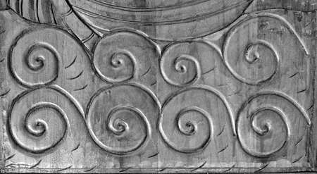 Wood carving detail of line pattern on black and dark background, wooden door, with fish texture carving, vintage decoration.の写真素材