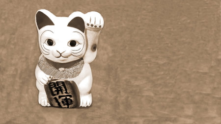 lucky cat japanese doll ingot mean symbol of luck charm, with white brown figurine known as maneki neko, isolated retro background.の写真素材