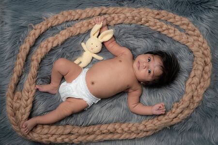 My Best Friend the baby sleeping with her teddy bear on grey fur bed sheet, New family and baby healthy conceptの写真素材