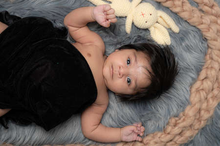 baby on grey background close-up,design element,space for text, with teddyの写真素材