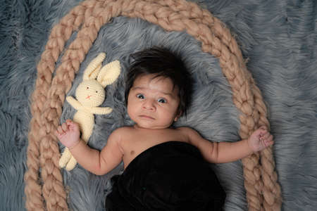 baby on grey background close-up, different emotions, design element,space for text, with teddyの写真素材