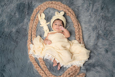 portrait of beautiful healthy baby Boy wrapped in woolen shawlの写真素材