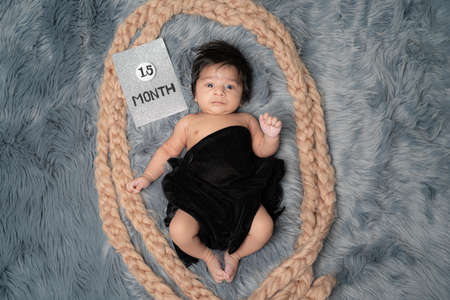 Close up of 1.5 month baby boy with black shawl,straight facing camera different posingの写真素材