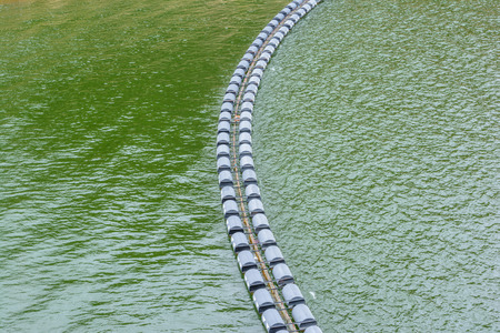 Floating equipment across waste on waterの写真素材