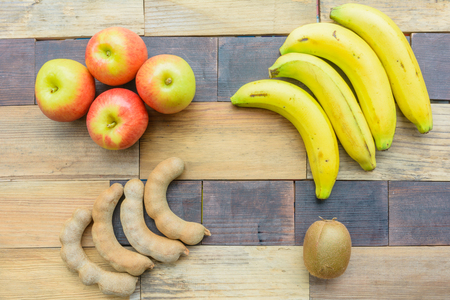 Apple, banana, kiwi and tamarind fruit backgroundの写真素材