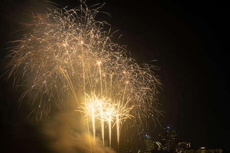 Firework festival with beach foreground and city background at Pattaya beach, Thailand. Colorful...
