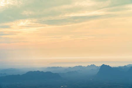 Sunrise at mountain cliff with mountain background. Nature park and outdoor landscape backgroundの写真素材