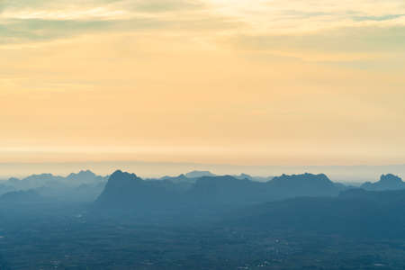 Sunrise at mountain cliff with mountain background. Nature park and outdoor landscape backgroundの写真素材