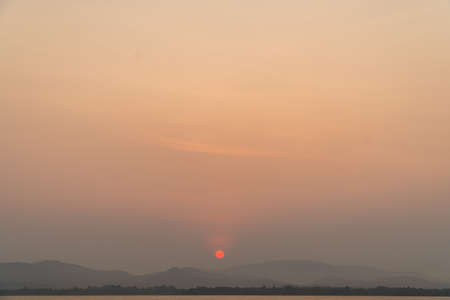 Sunrise with clouds and blue sky background. Nature and outdoor background in water reservoir at Thailandの写真素材