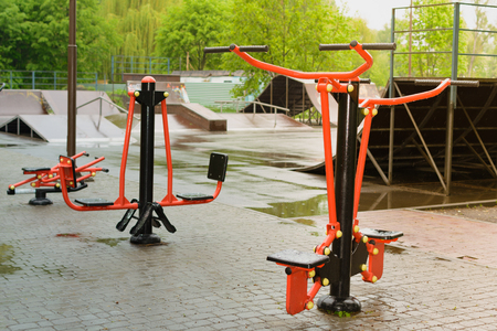 Training apparatus in the park. In the background is a skateboarding ground.の写真素材