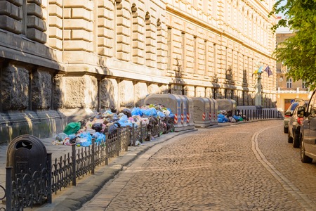 Trash near containers in the streetsの写真素材