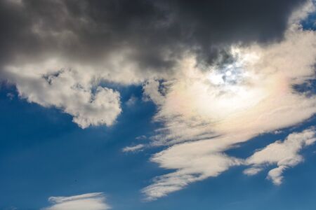 The sun was hidden by clouds in the skyの写真素材