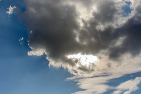 The sun was hidden by clouds in the skyの写真素材