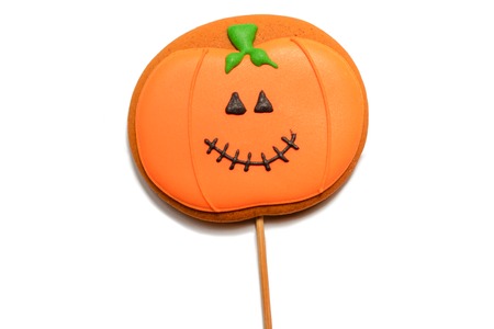 Halloween gingerbread cookie isolated. Halloween orange pumpkin sugar biscuit. Treats for Halloween party. Isolated on whiteの写真素材
