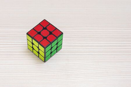 TERNOPIL, UKRAINE, NOVEMBER 27, 2018: Rubiks cube with red, yellow and green on the sides with black inserts on the tableのeditorial素材