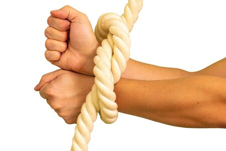Mens hands are tied in ropes and clenched in their fists.の写真素材