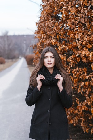 beautiful girl near autumn tree.の写真素材