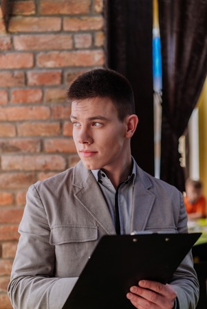 Portrait of beautiful elegant business guy. Cafe.の写真素材