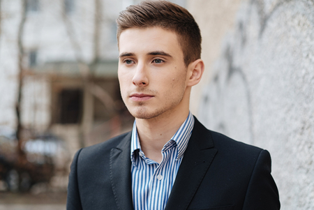 Portrait of serious good-looking man with blue eyes and suitの写真素材