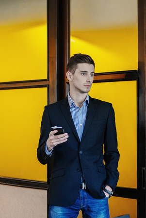 Portrait of a young businessman on phone.の写真素材