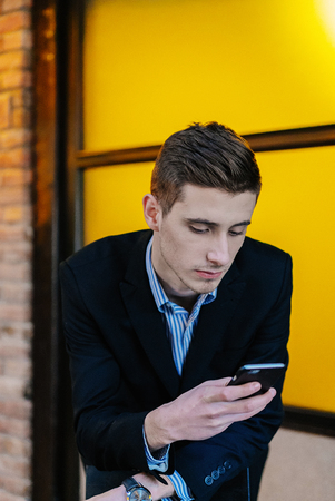 Portrait of a young businessman on phone.の写真素材