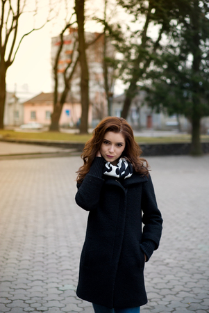 Beautiful girl in autumn park, posing for the cameraの写真素材