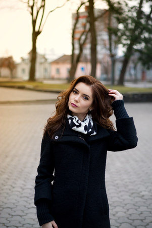 Beautiful girl in autumn park, posing for the cameraの写真素材