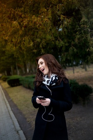 young hipster stylish beautiful girl listening to music, mobile phoneの写真素材