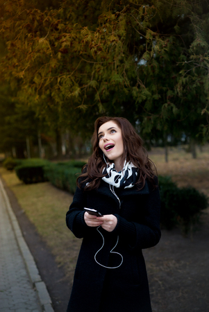 young hipster stylish beautiful girl listening to music, mobile phoneの写真素材