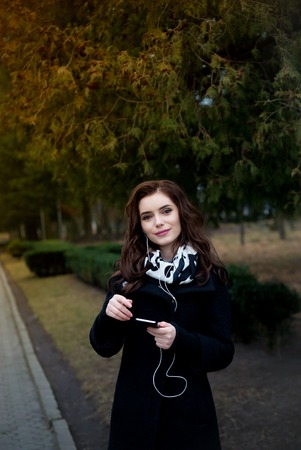 young hipster stylish beautiful girl listening to music, mobile phoneの写真素材