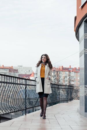 Outdoor lifestyle portrait of pretty young girl posing on stairway, wearing in casual style with sunglasses on urban background.の写真素材