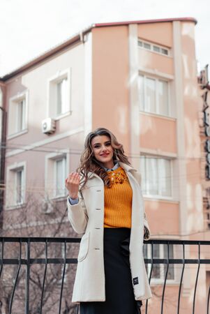 Outdoor lifestyle portrait of pretty young girl posing on stairway, wearing in casual style with sunglasses on urban background.の写真素材