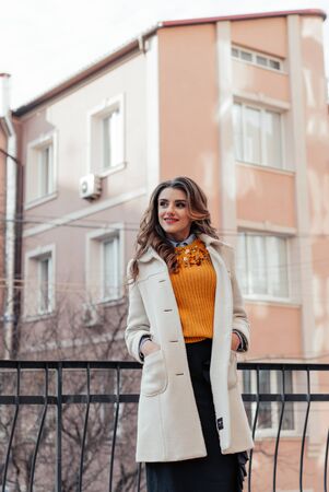 Outdoor lifestyle portrait of pretty young girl posing on stairway, wearing in casual style with sunglasses on urban background.の写真素材