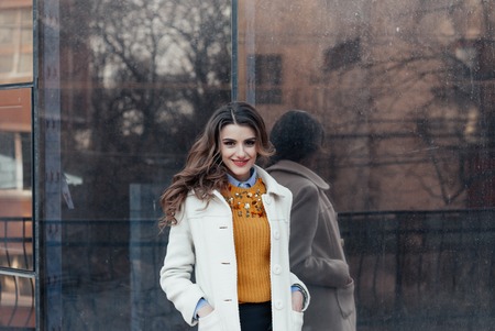 Outdoor lifestyle portrait of pretty young girl posing on stairway, wearing in casual style with sunglasses on urban background.の写真素材