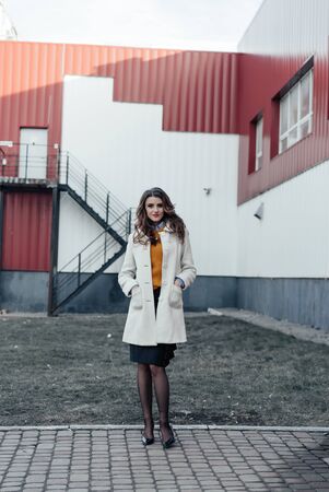 Outdoor lifestyle portrait of pretty young girl posing on stairway, wearing in casual style with sunglasses on urban background.の写真素材