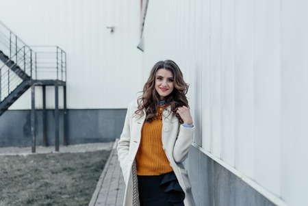 Outdoor lifestyle portrait of pretty young girl posing on stairway, wearing in casual style with sunglasses on urban background.の写真素材