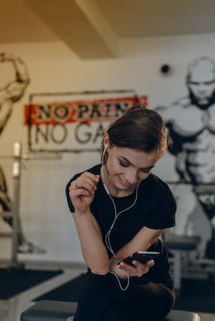 Smiling and happy girl at the gymの写真素材