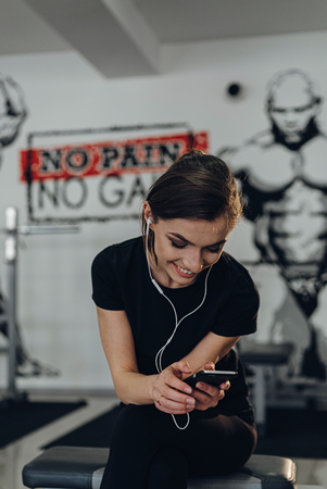 Smiling and happy girl at the gymの写真素材