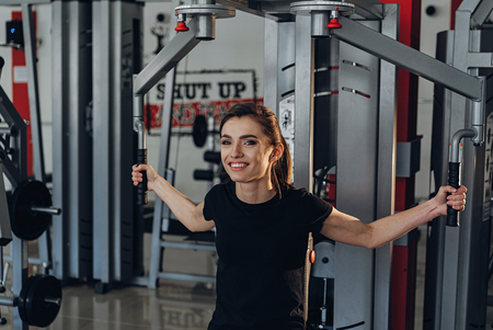 beautiful girl is engaged on a simulator at the fitness clubの写真素材